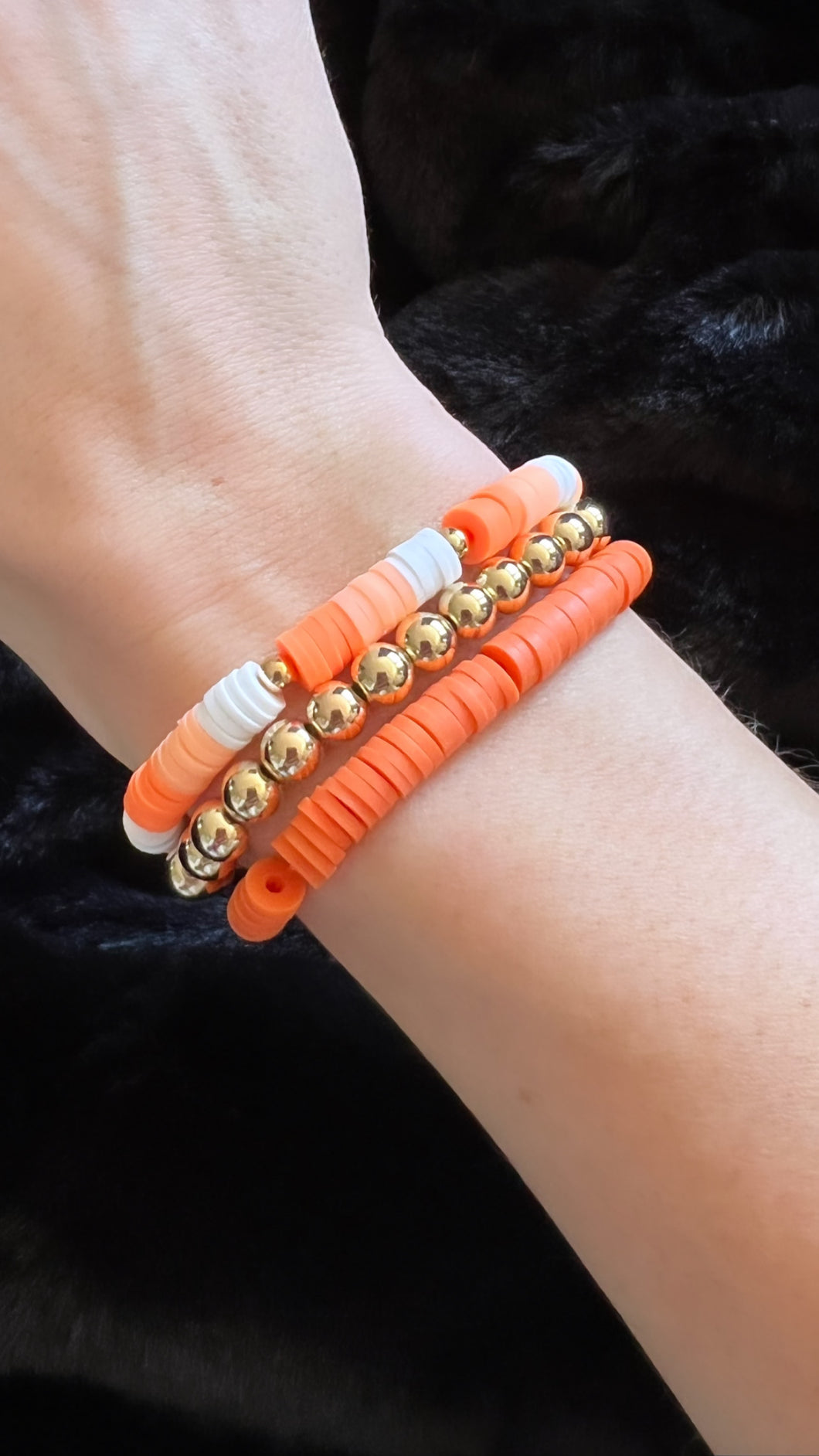 Stack of Orange Clay Bead Bracelet